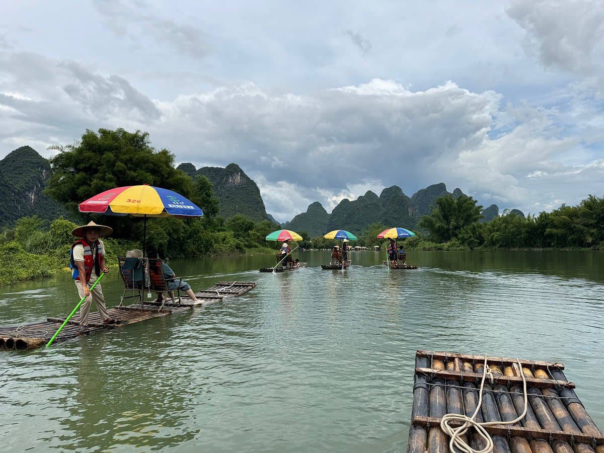 Bamboo rafts with colorful umbrellas gliding the Yulong River