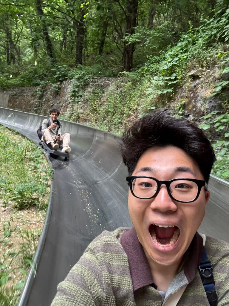 Daniel from the USA laughing on the Mutianyu toboggan slide