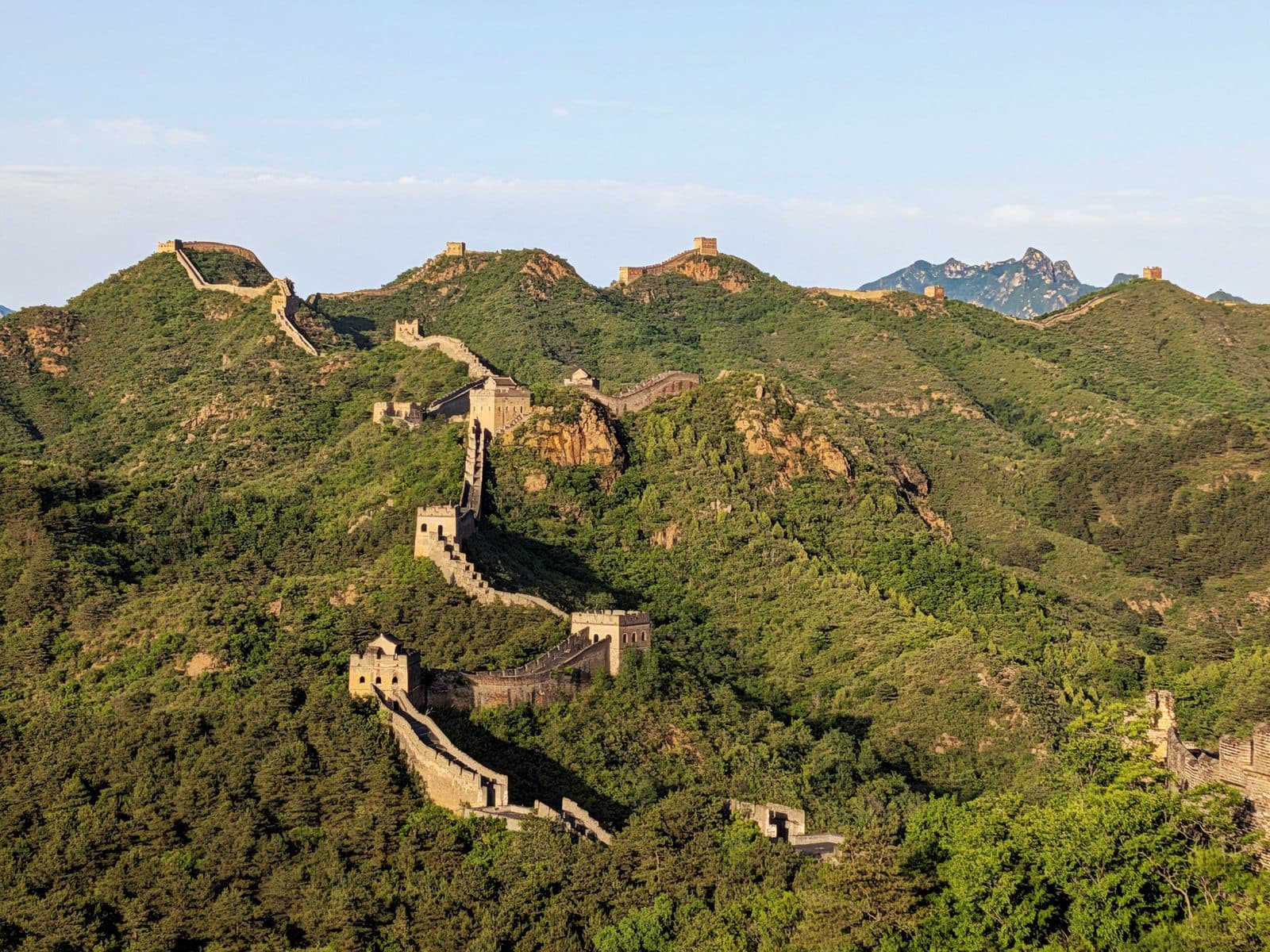 Golden-hour light over the restored towers of Jinshanling Great Wall